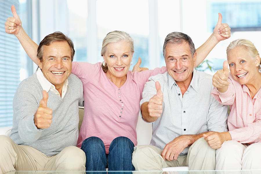 Group of men and women gesturing thumbs up sign Photograph by GlobalStock