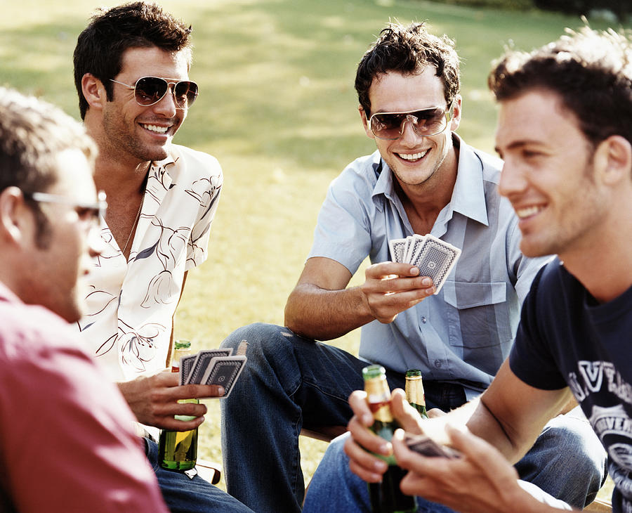 Group of Men Playing Cards and Drinking Beer Photograph by Digital Vision.