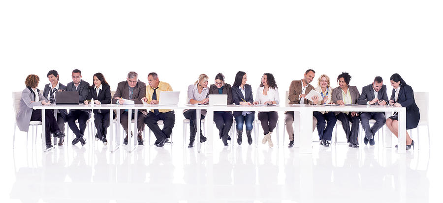Group of multi-tasking business people isolated on white. Photograph by BraunS