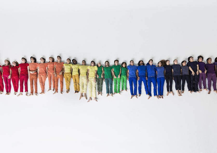 Group of People Forming a Rainbow on Studio Floor Photograph by Nisian Hughes