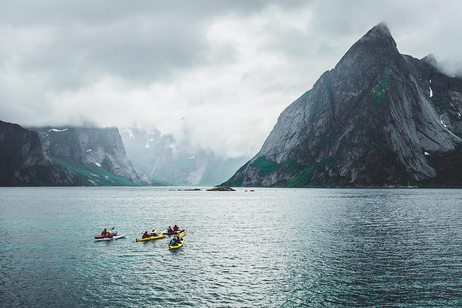 Group of people kayaking near Reine, Moskenes, Lofoten Islands, Norway Photograph by by Tatsiana Volskaya