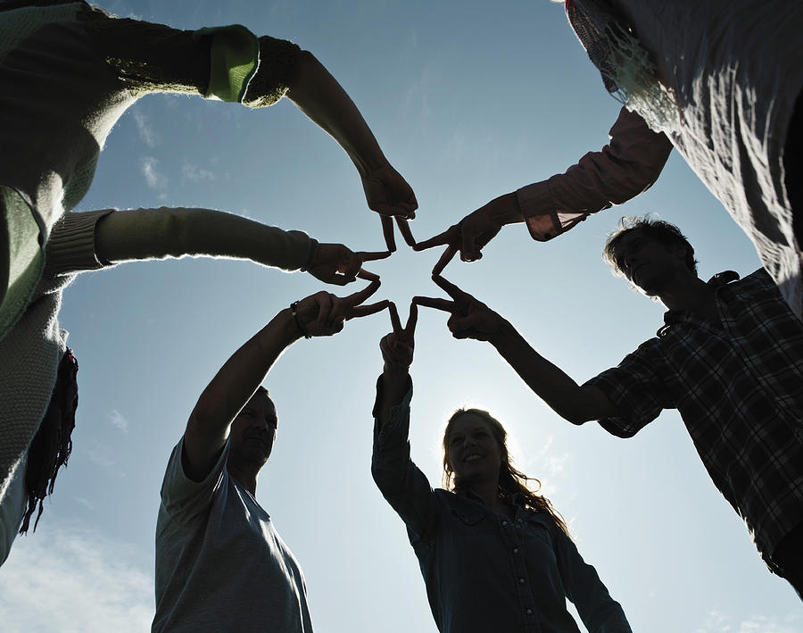 Group of people making a star with hands. Photograph by David Trood
