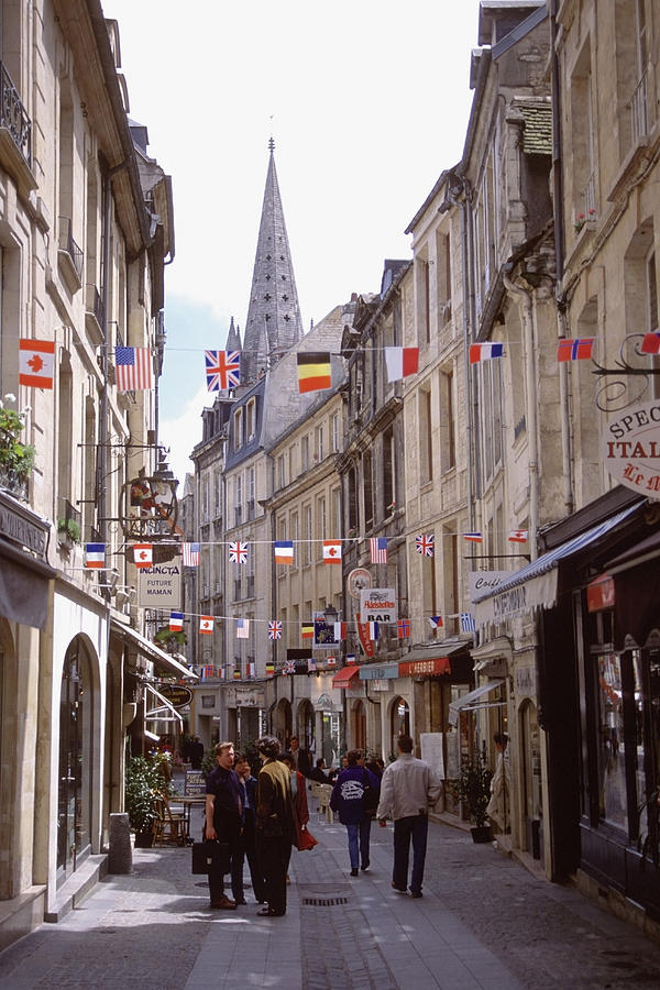 Group of people walking on a street, Caen, Normandy, France Photograph by Medioimages/Photodisc