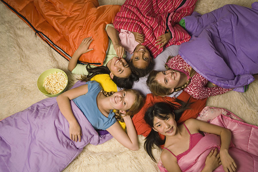 Group of preteen girls in sleeping bags Photograph by Jupiterimages