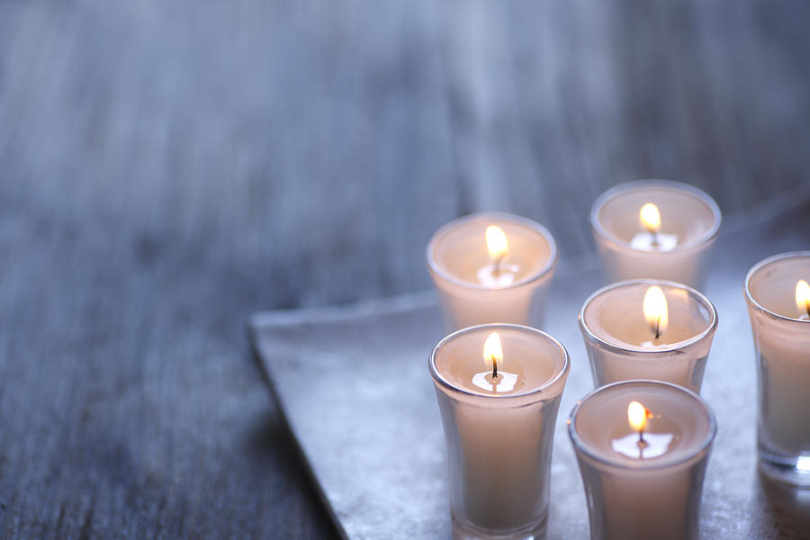 Group of small lit votive candles Photograph by Dny59