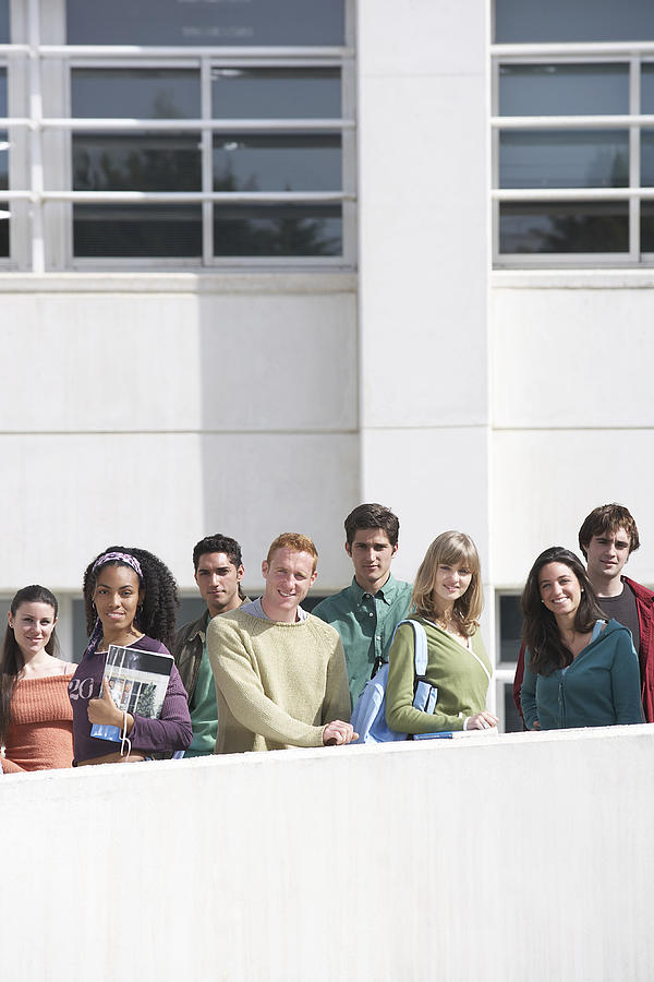Group of students standing on walkway, outdoors, portrait Photograph by Nick White