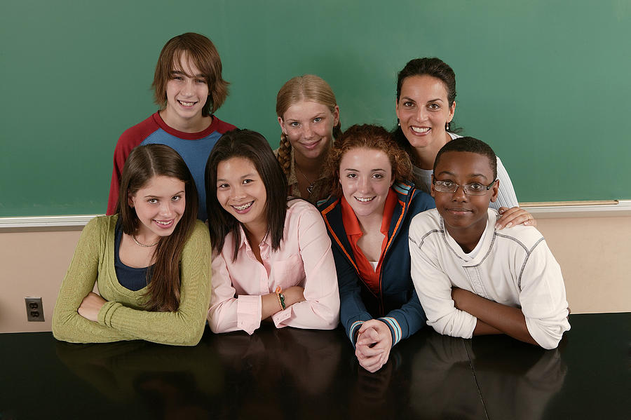 Group of teenagers with teacher at school Photograph by Comstock Images