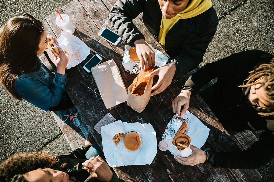 Group of Young Adults Eating Fast Food Photograph by RyanJLane