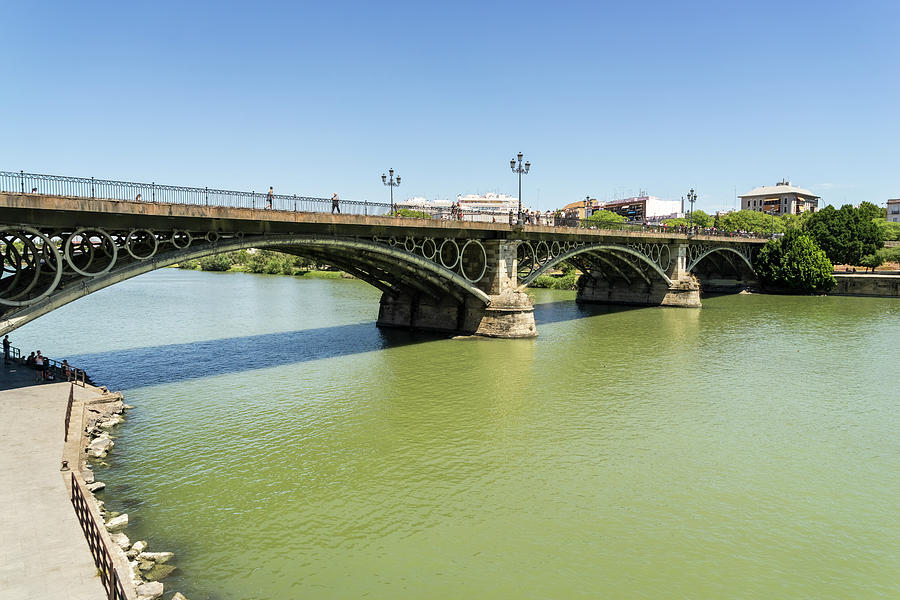 Guadalquivir River and Triana Bridge Puente de Isabel II - Quintessential Seville Andalusia Spain Photograph by Georgia Mizuleva