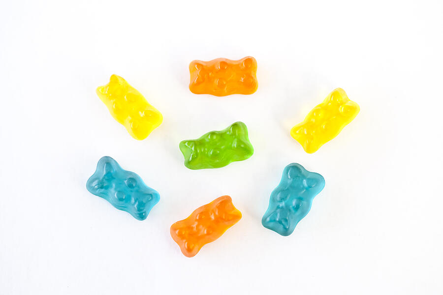 Gummy bears on white background Photograph by Jenny Dettrick