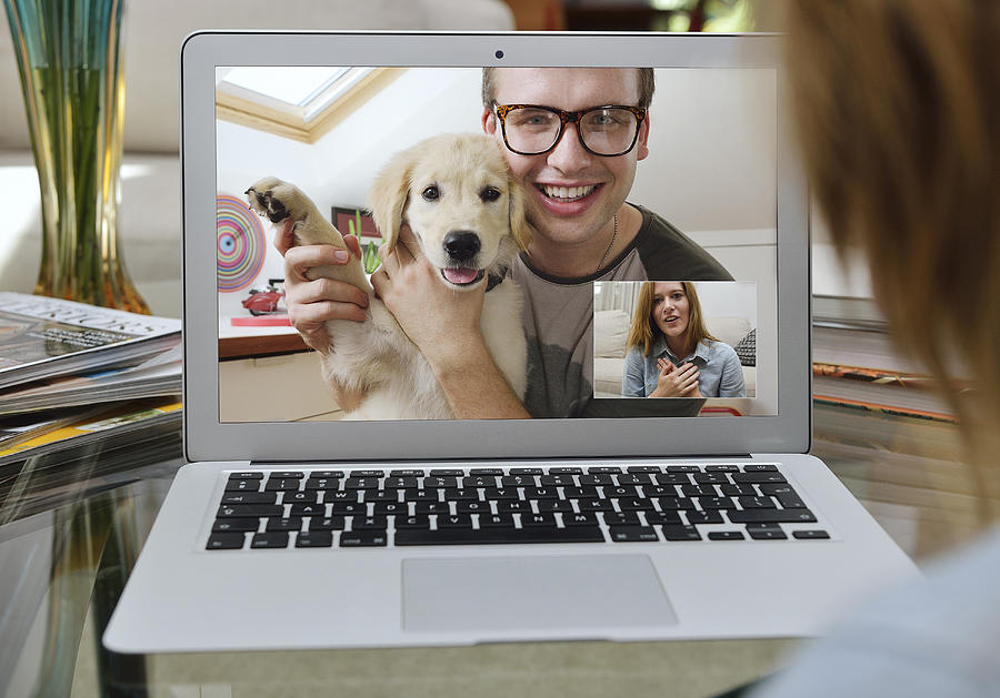 Guy showing off his new puppy over Skype. Photograph by David Malan