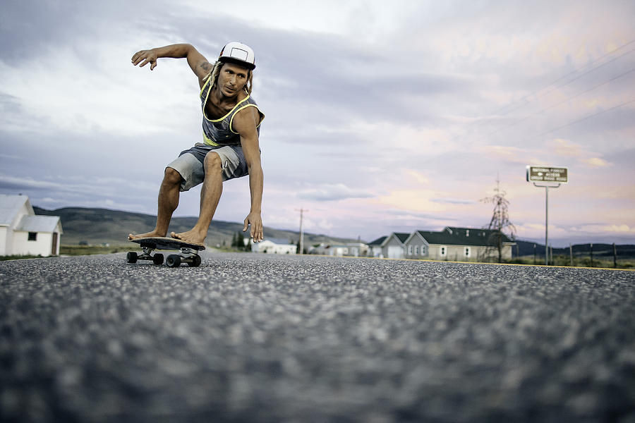 Guy turining on his skateboard at sunset. Photograph by Daniel Milchev