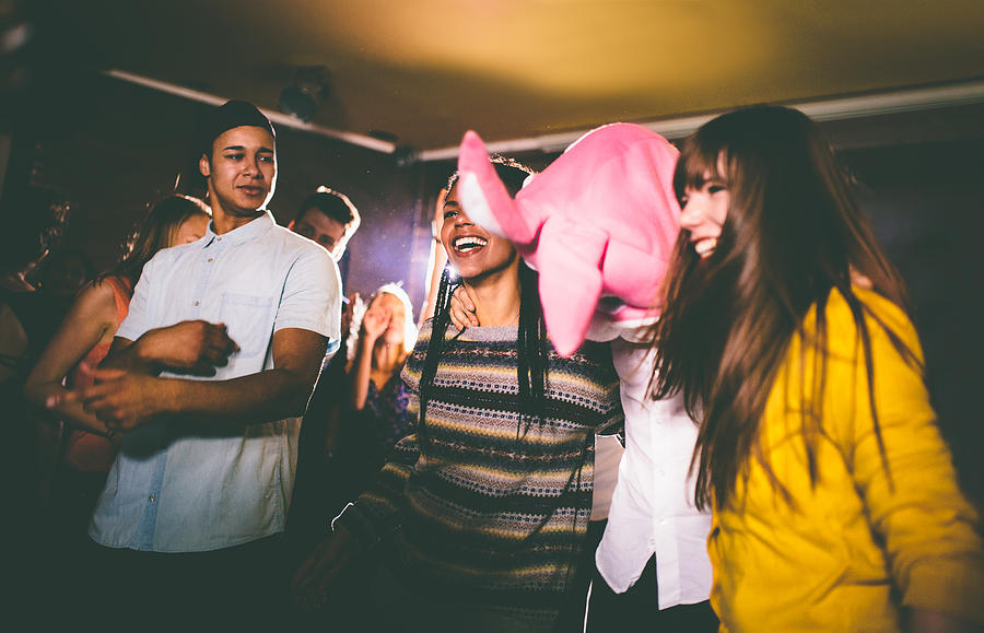 Guy with a bunny head with friends at party Photograph by Wundervisuals