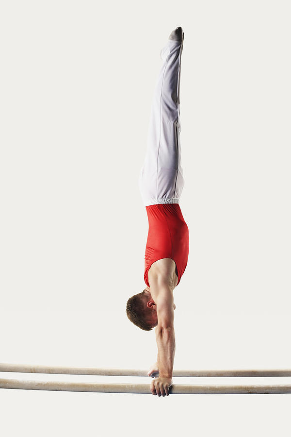 Gymnast Doing Handstand on Parallel Bars Photograph by Fuse
