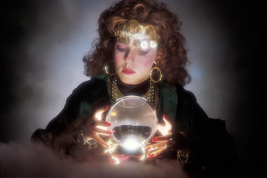 Gypsy looking in crystal ball Photograph by Comstock