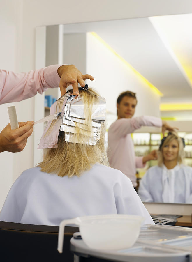 Hairdresser Applying Hair Dye to a Womans Hair Photograph by Rayman