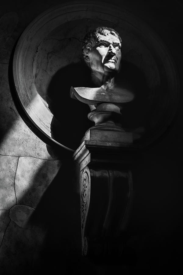 Julius Caesar Photograph - Half-length Statue Portrait Black And White Vertical Background In The Dark With Sunrays Filter Through Shadows. by Luca Lorenzelli