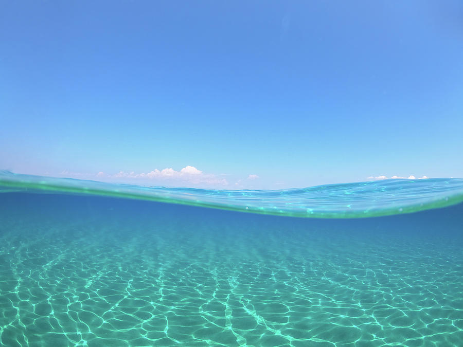 Half Underwater View of Crystal Clear Waters and Clear Sky Photograph by Alexios Ntounas