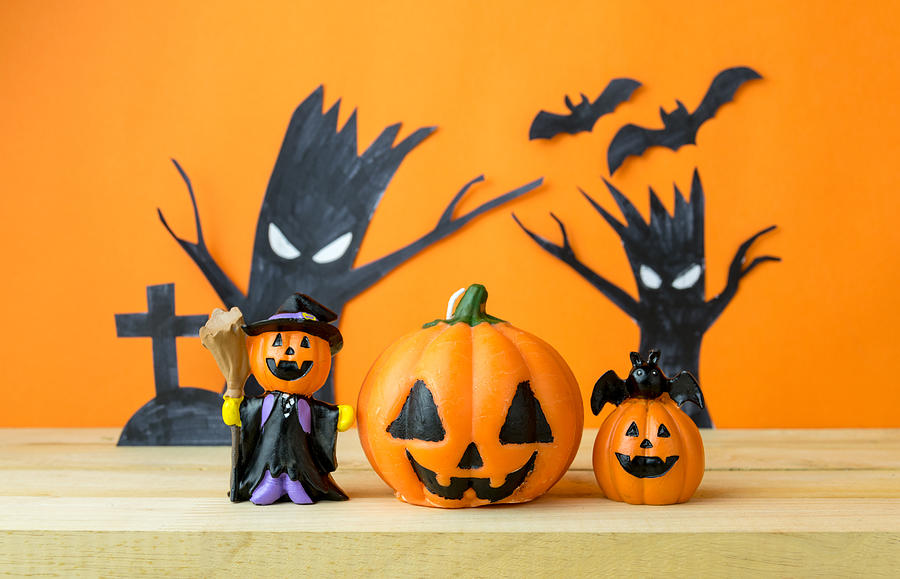 Halloween Pumpkins on wooden table Photograph by Zenstock