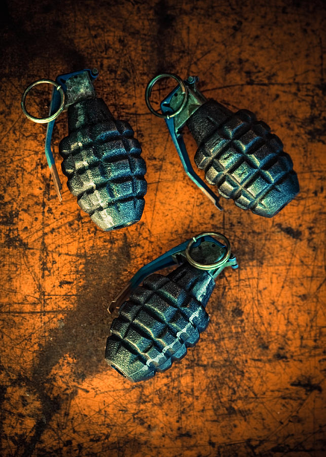 Hand Grenades On Orange Background Photograph by Thepalmer