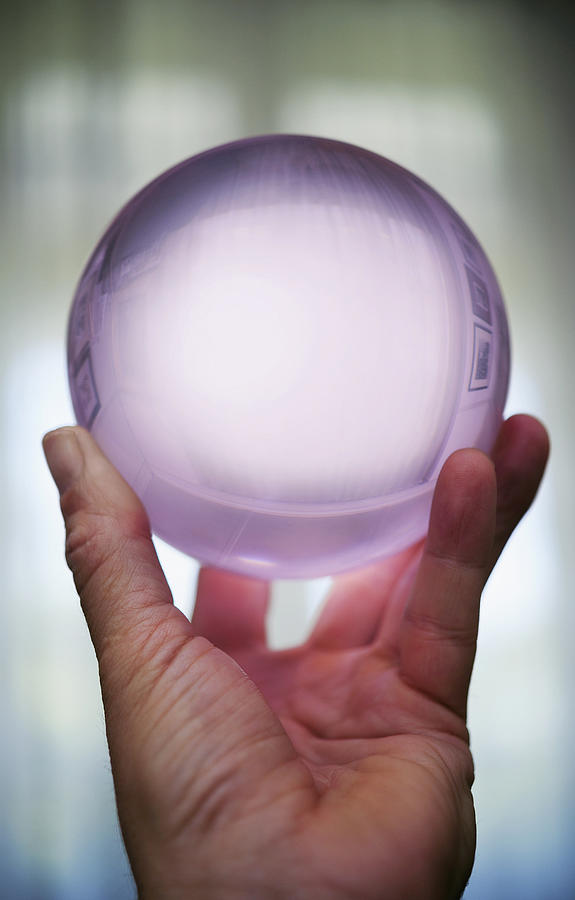 Hand holding a crystal ball. Photograph by David Malan