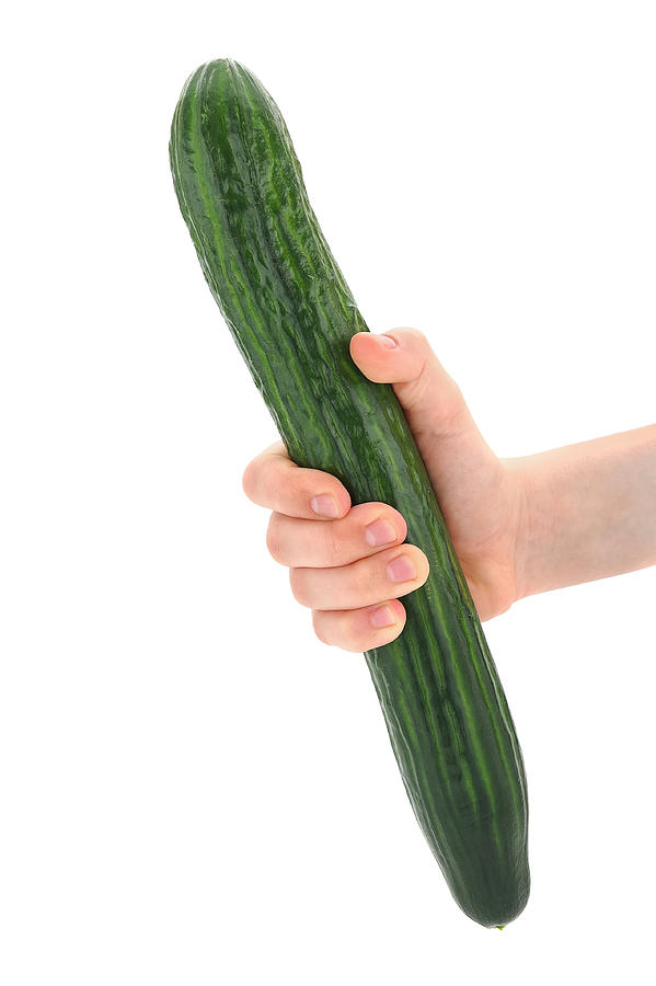 Hand holding a cucumber Photograph by Ckurat