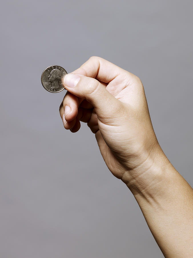 Hand Holding A Quarter (25 Cents) Photograph by Ballyscanlon