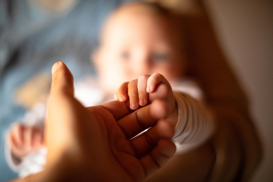 Hand holding newborn babys hand Photograph by Marco_Piunti