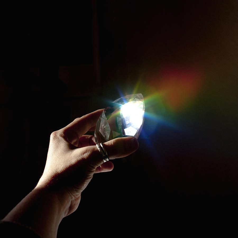 Hand Holding Prism Refracting Rainbow Light Photograph by Sarah Palmer