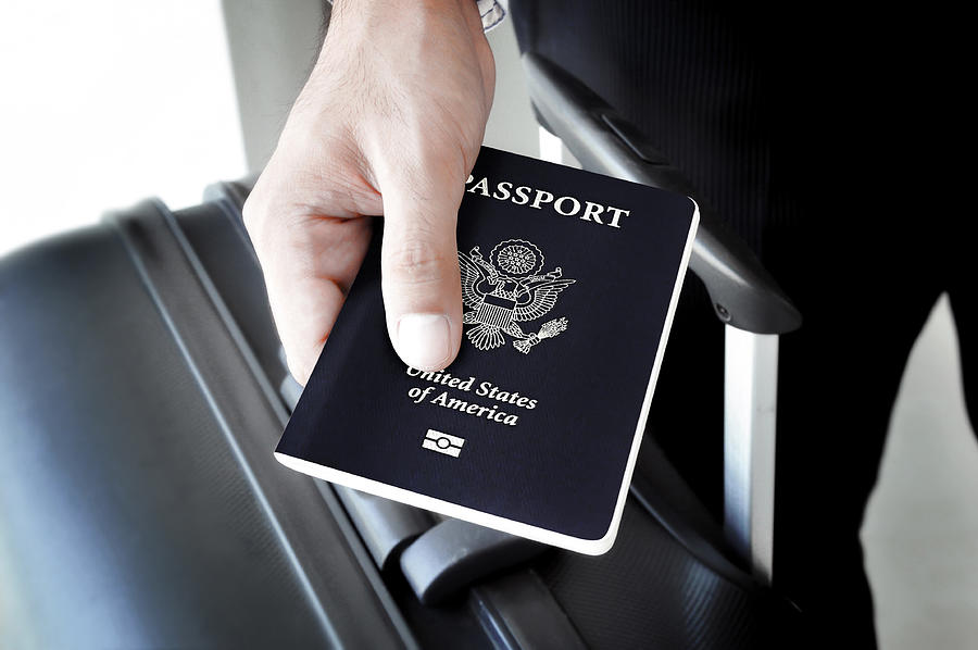 Hand holding U.S. passport Photograph by Atstock Productions