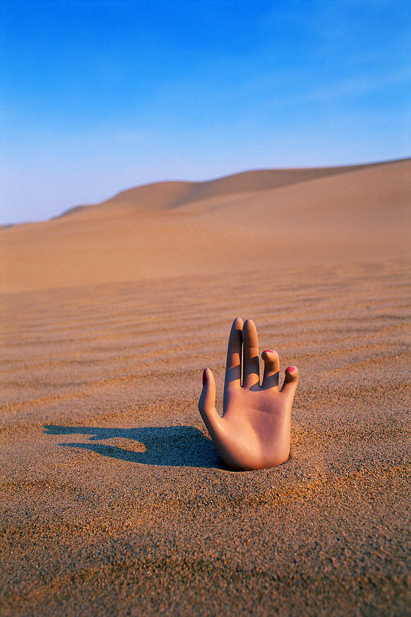 Hand in desert Photograph by Thinkstock Images