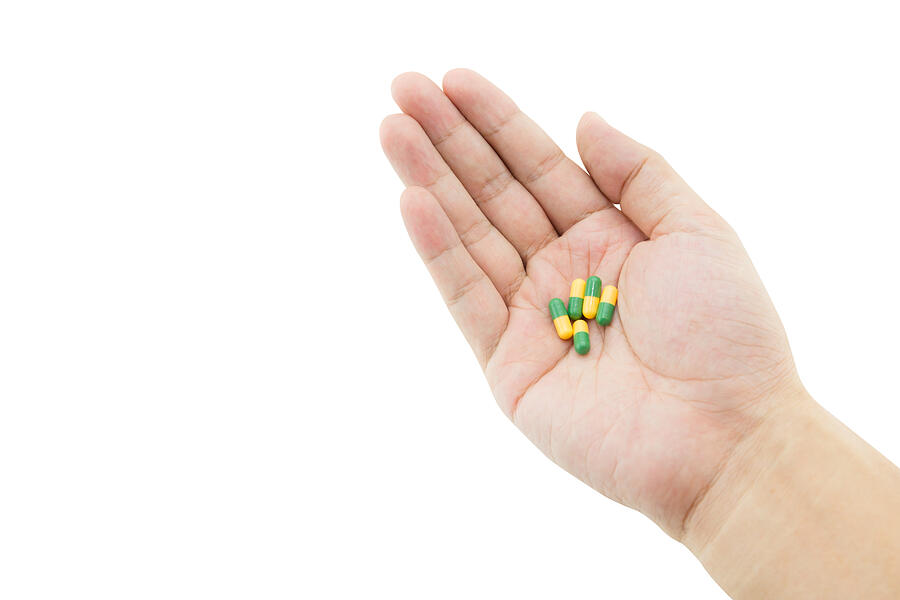 Hand Of A Man With Some Capsule Pills Photograph by Narith_2527
