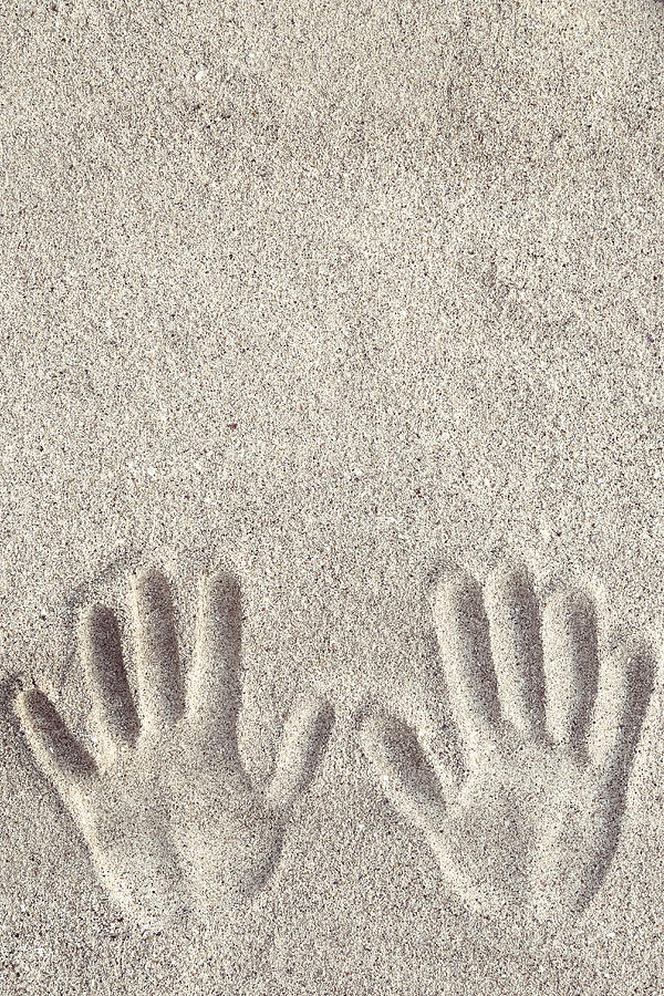 Hand prints on the sand Photograph by Triocean