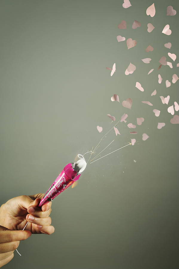 hand pulling string of party popper,Heart Photograph by Yagi Studio