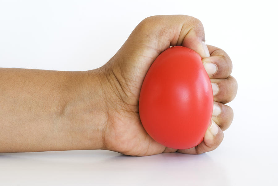 Hand squeezing stress ball Photograph by Vkbhat