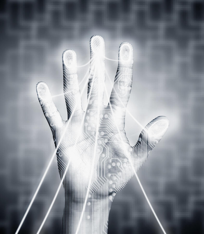 Hand with electricity streaming out Photograph by Martin Barraud