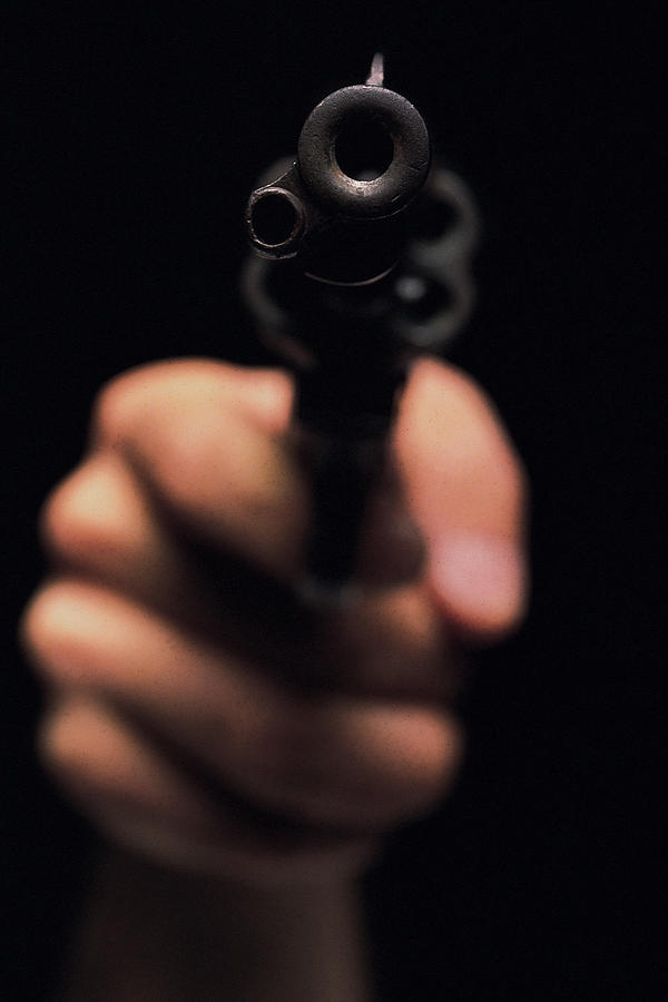 Hand with gun Photograph by Comstock
