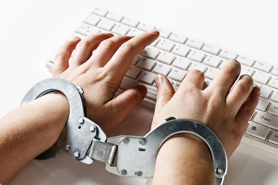 Handcuffed to her computer: very demanding job or censorship Photograph by RapidEye