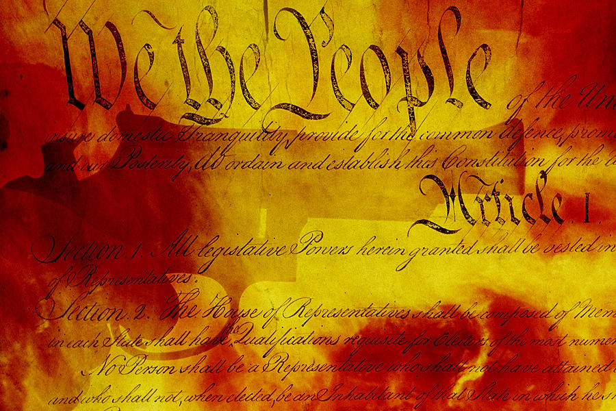 Handgun, USA Constitution, fiery background. Photograph by Harald Sund