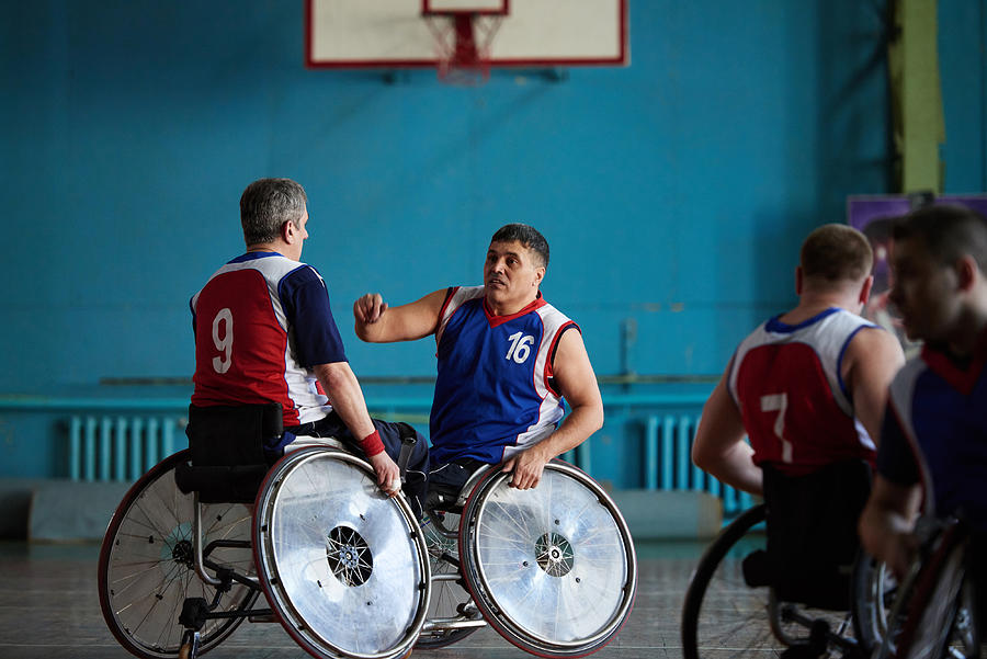 Handicapped basketball players discussing match Photograph by CliqueImages
