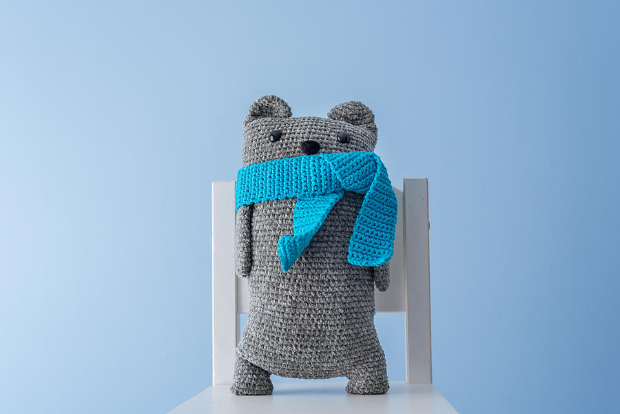 Handmade crocheted teddy bear with a blue scarf Photograph by Click&Boo