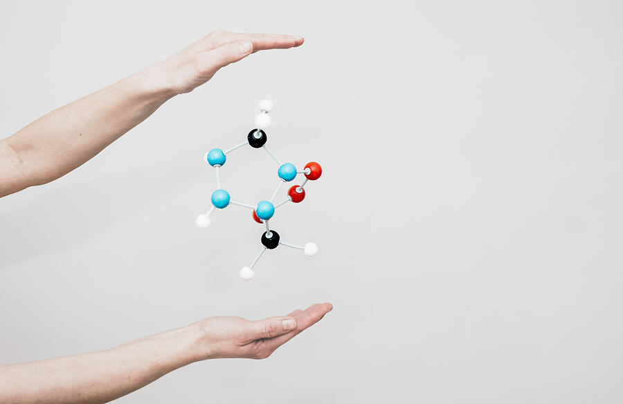 Hands and molecule model. Photograph by Guido Mieth