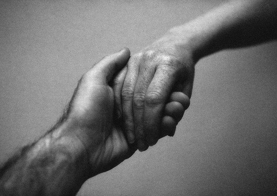 Hands clasping, close-up, b&w Photograph by Laurent Hamels