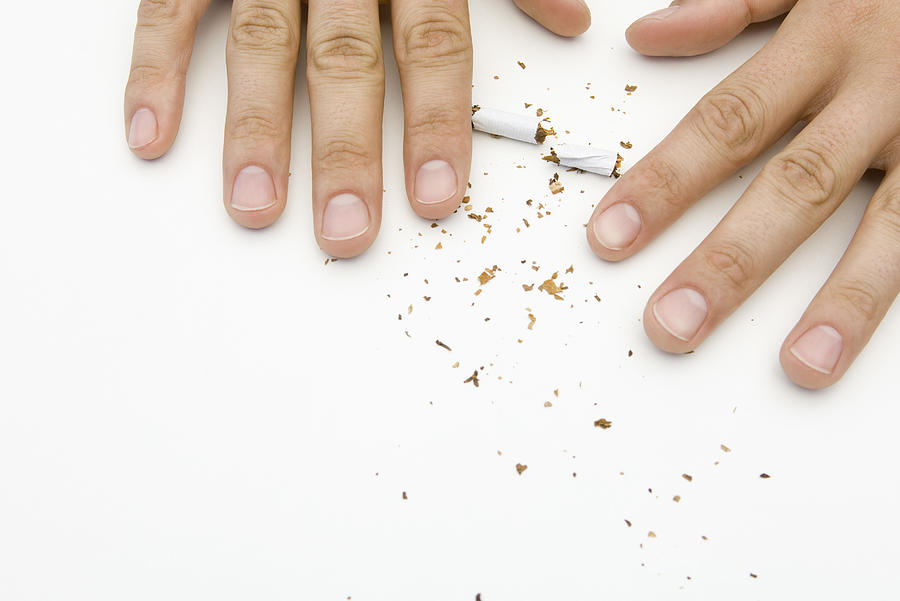 Hands destroying cigarette, cropped Photograph by PhotoAlto/Michele Constantini