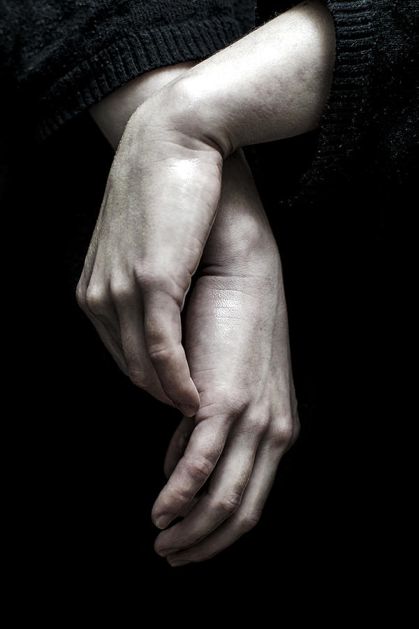 Hands of a young woman isolated on dark background Photograph by Jinjo0222988