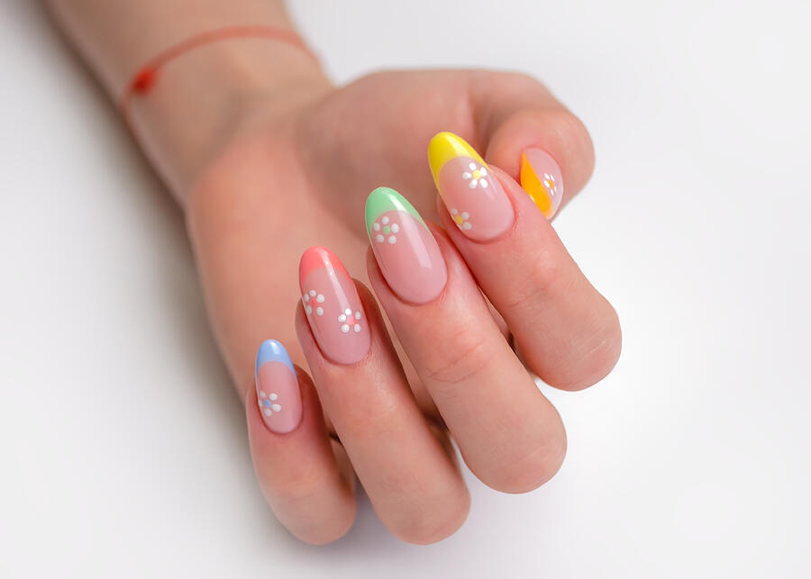 Hands of a young woman with a manicure. The nails are covered with gel polish with colored French and flowers Photograph by Yuliya Ufimtseva Hands of a young woman with a manicure. The nails are covered with gel polish with colored French and flowers Photograph by Yuliya Ufimtseva