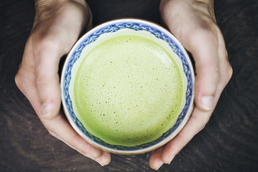 Hands of man holding a cup of Japanese powdered green tea Photograph by Kohei Hara