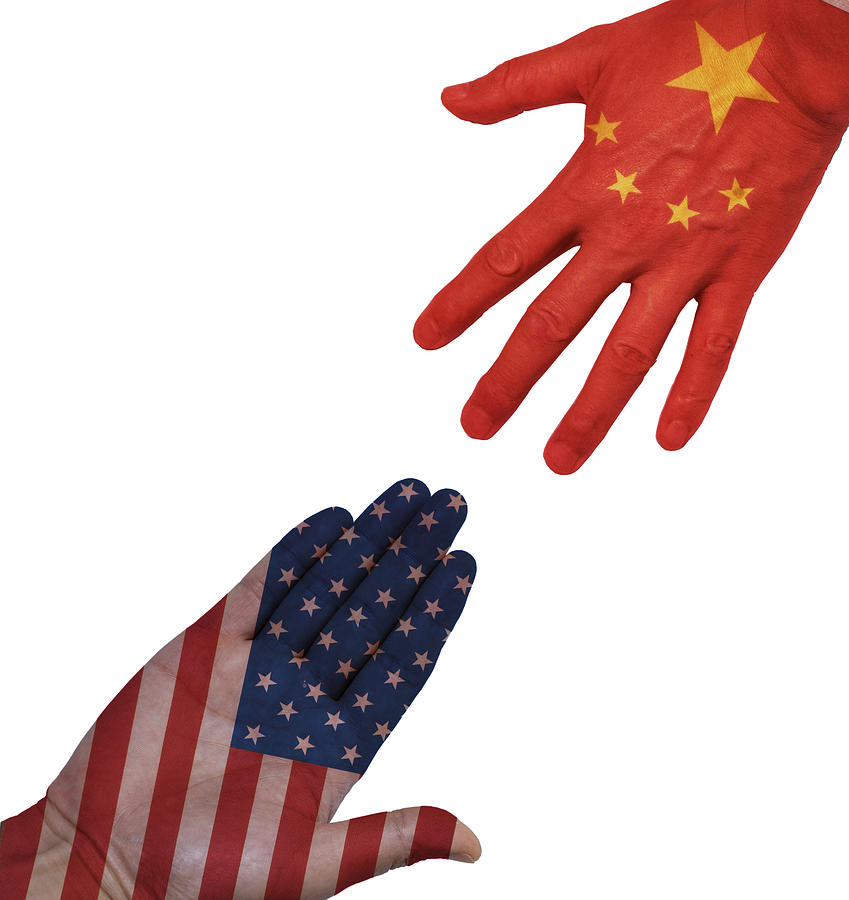 Hands people against the backdrop flags USA and China Photograph by Yaorusheng