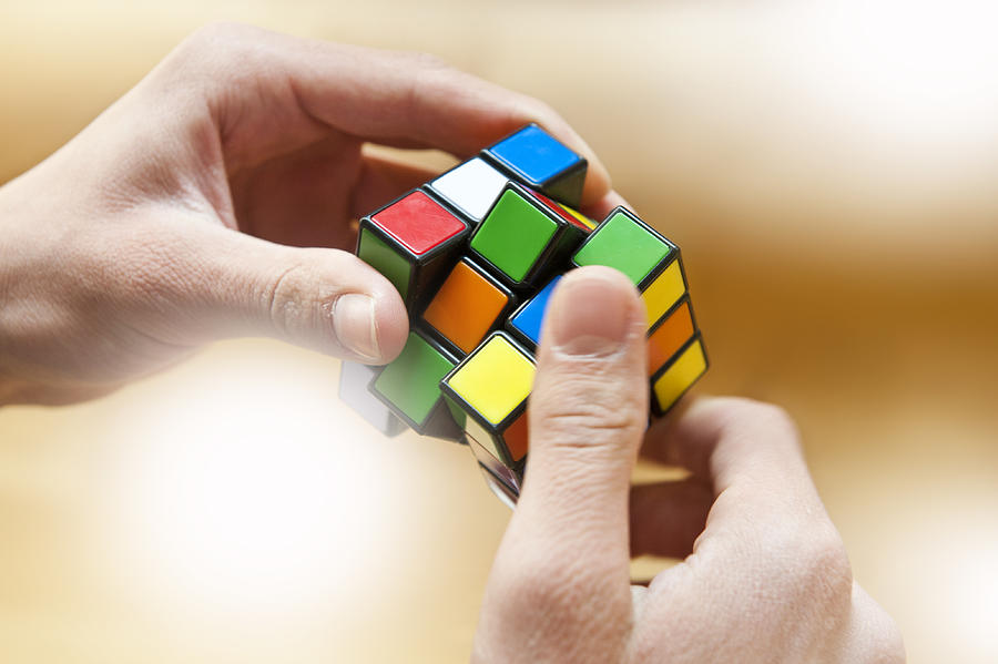 Hands playing a cube game Photograph by Vitranc Hands playing a cube game Photograph by Vitranc
