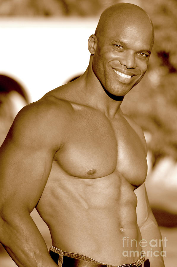 Handsome black muscular man poses showing off his great smile and great body. Photograph by Gunther Allen